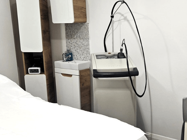 Treatment room at Prima Britannia Laser Clinic in London featuring medical-grade laser hair removal equipment.